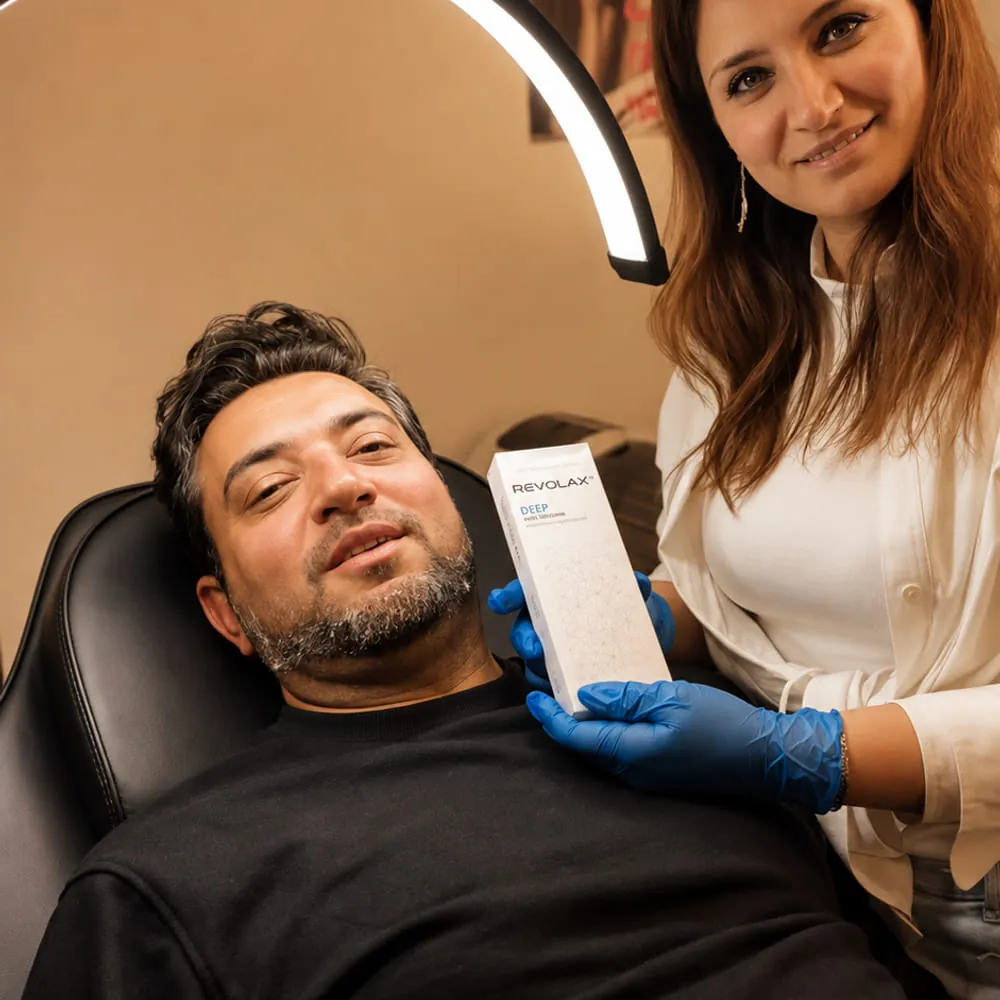 Dr Mari showing a client the dermal filler being used in their treatment